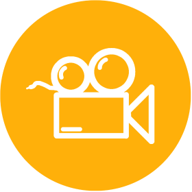 Icon of a video camera with a film reel and two large circles representing the lens, on a yellow circular background.