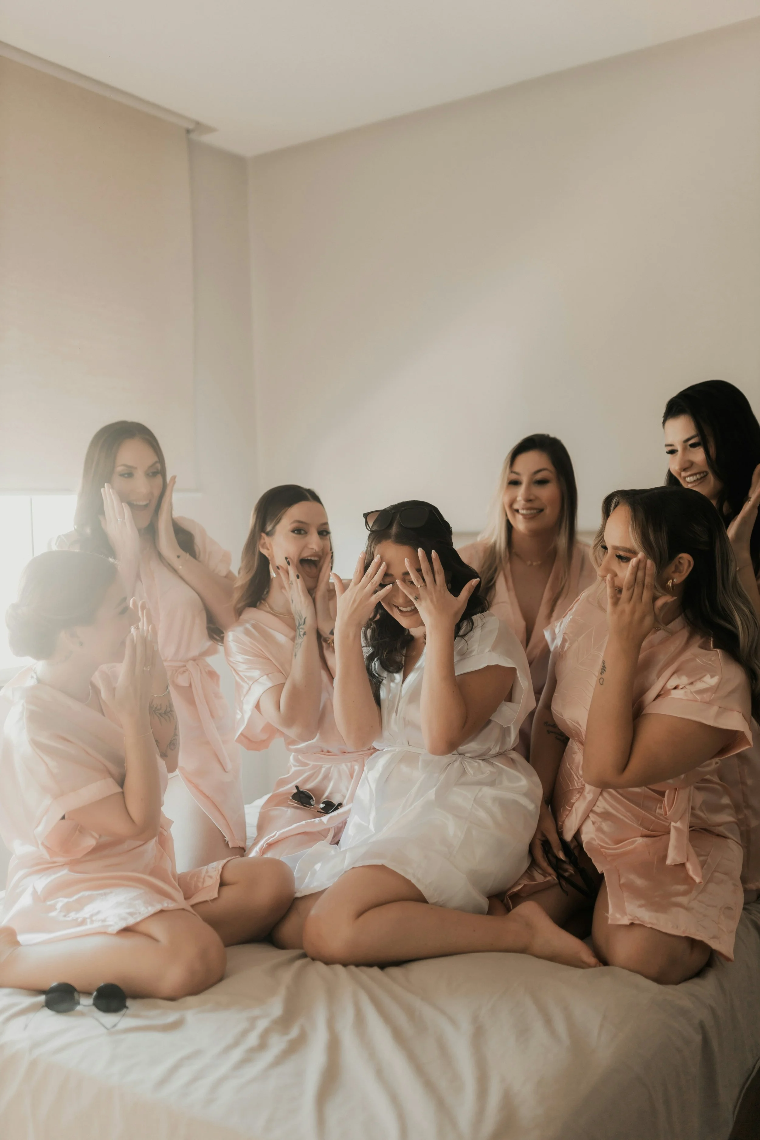 A group of participants sharing laughter and connection during a private, facilitated workshop experience in a relaxed indoor setting.