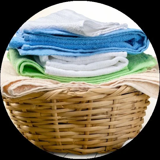 Wicker basket with colorful folded towels.