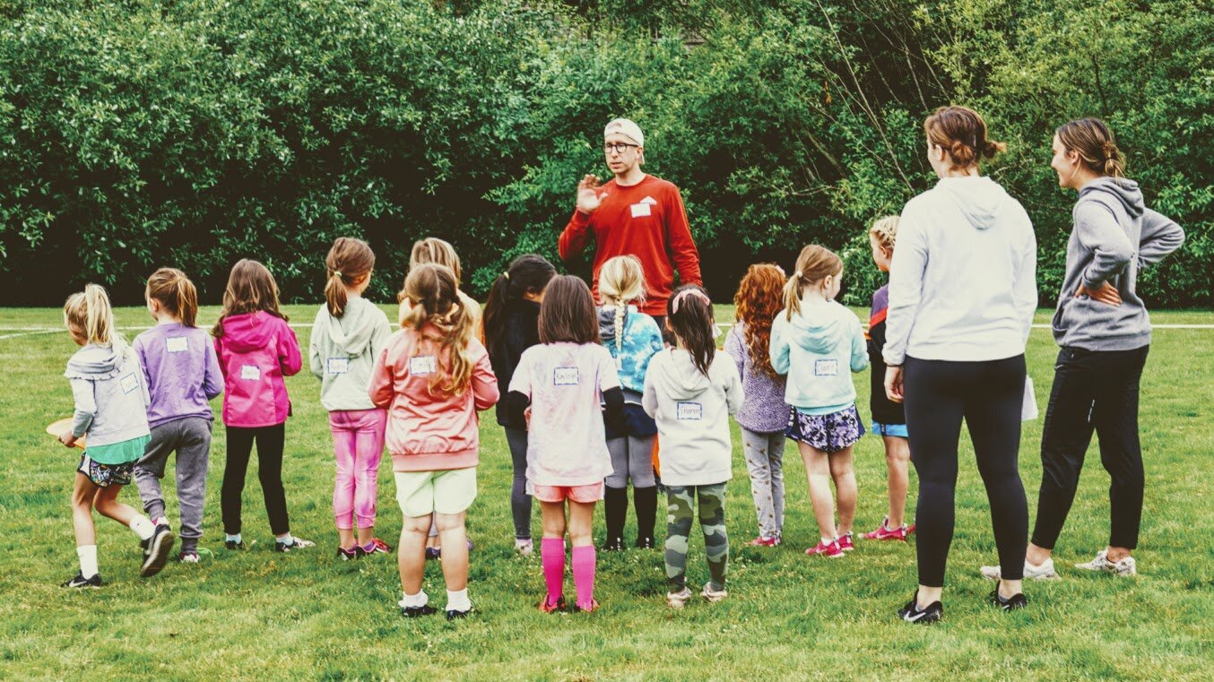 Girls learning football skills at Girls Sports Club clinic