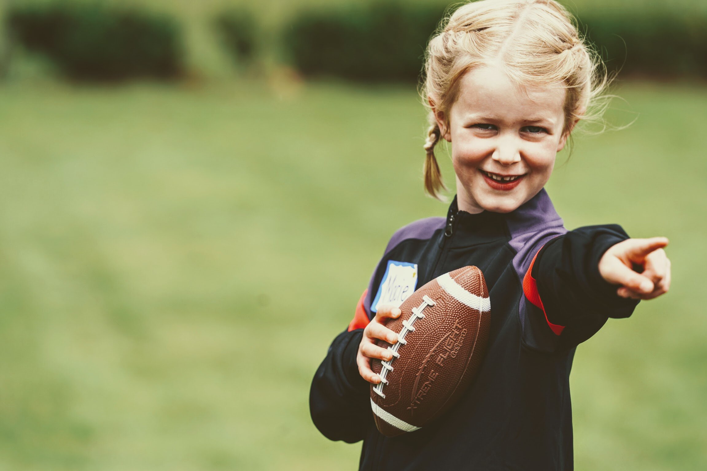 Girl learning football skills at Girls Sports Club clinic