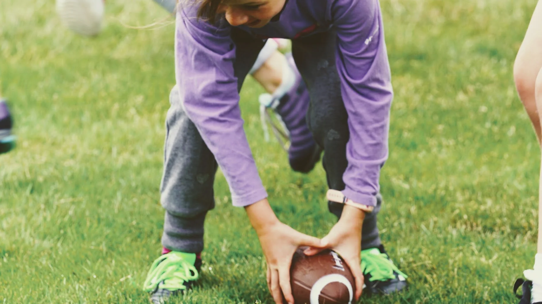 Girls learning football skills at Girls Sports Club clinic