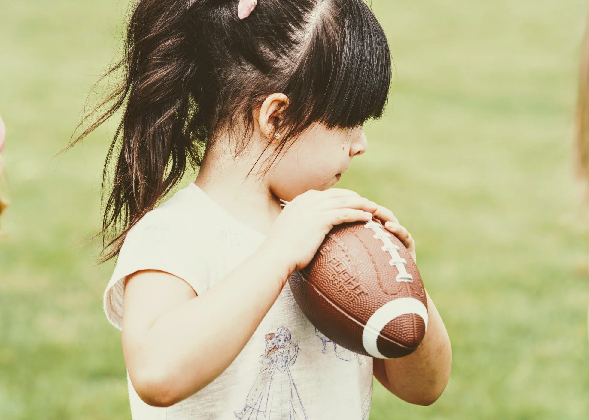 Girls learning football skills at Girls Sports Club clinic