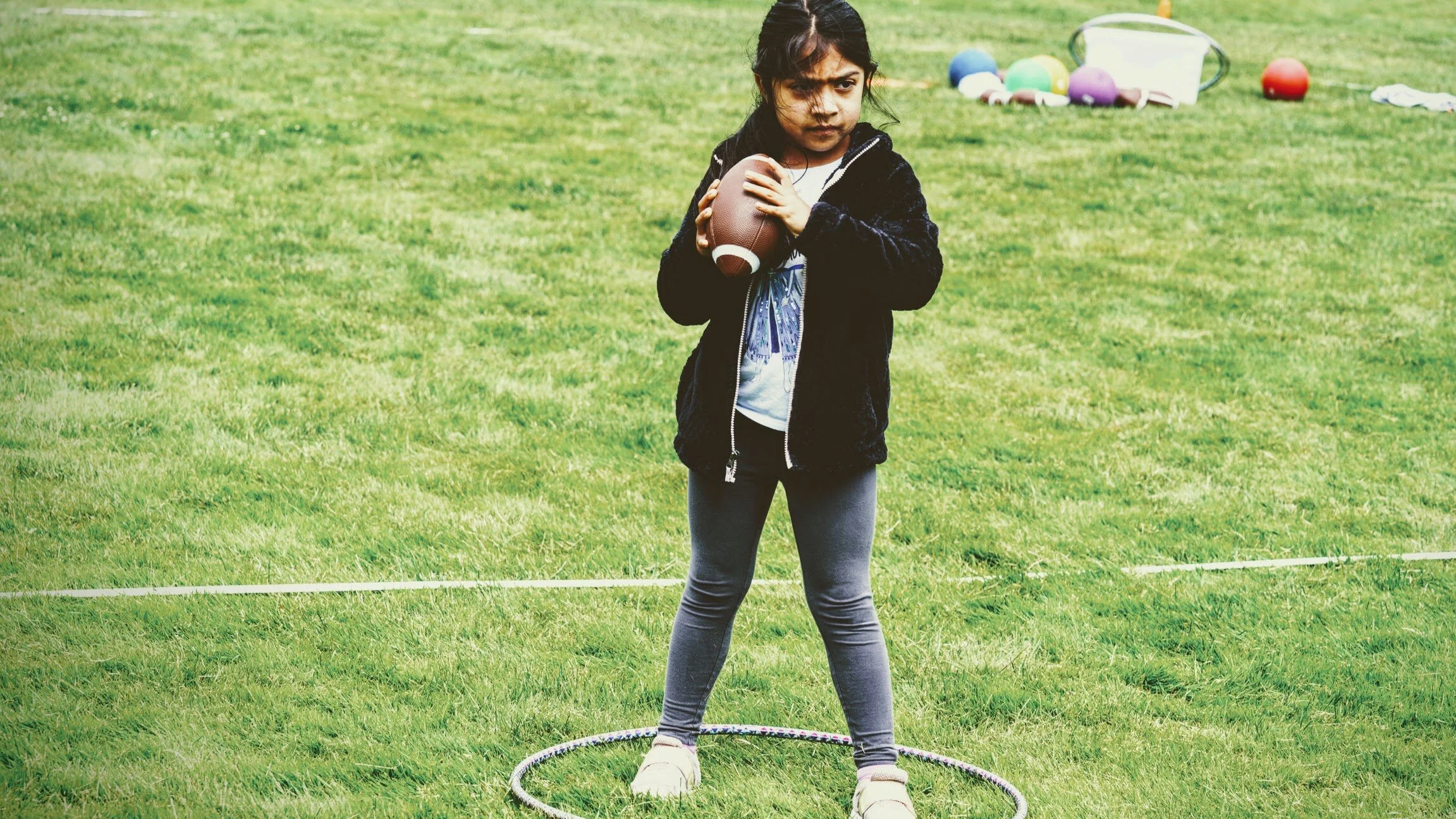 Girls learning football skills at Girls Sports Club clinic