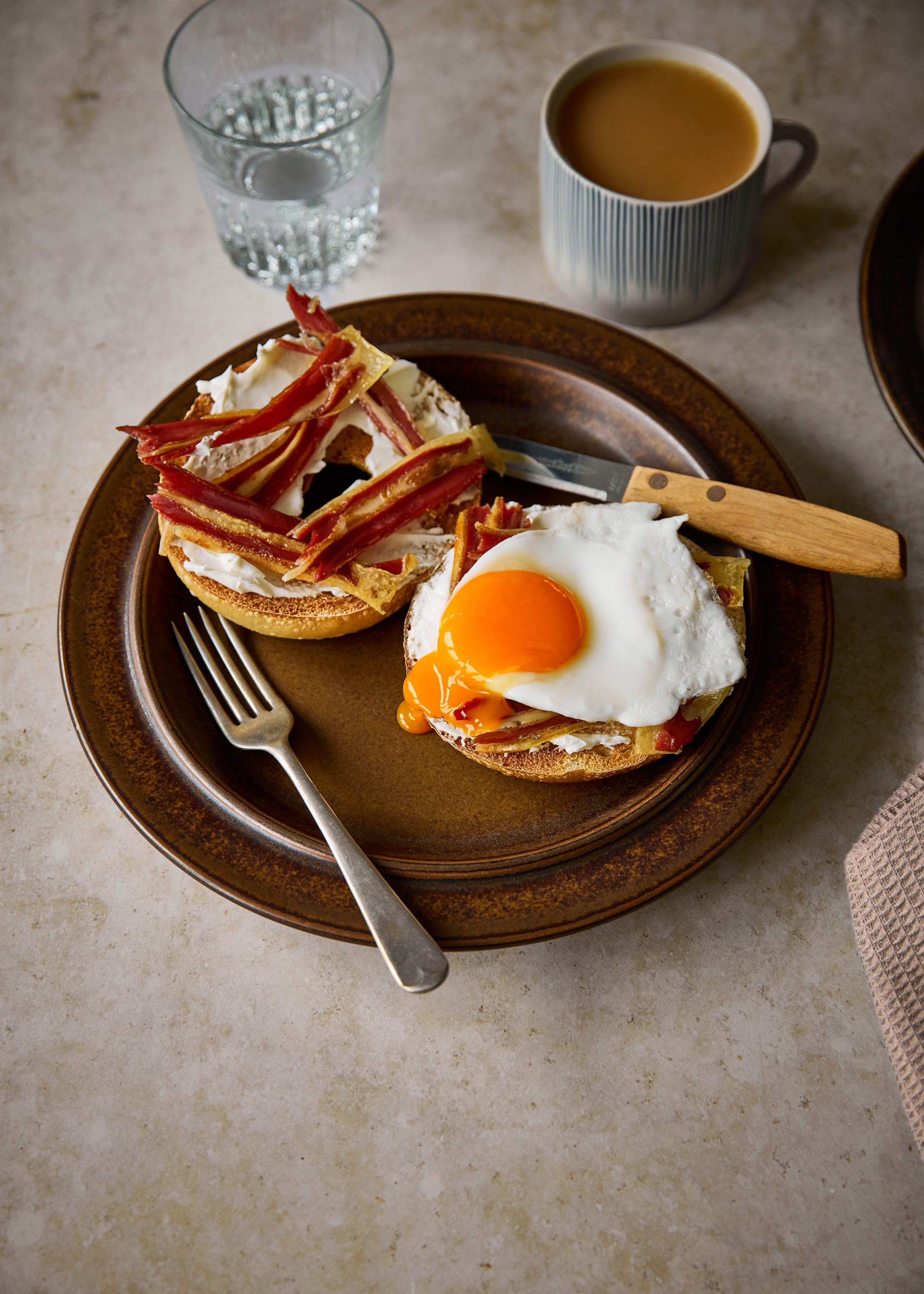 Meat-free bacon and fried egg on a cream cheese bagel