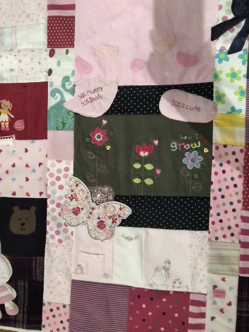 memory quilt handmade from baby girl clothes