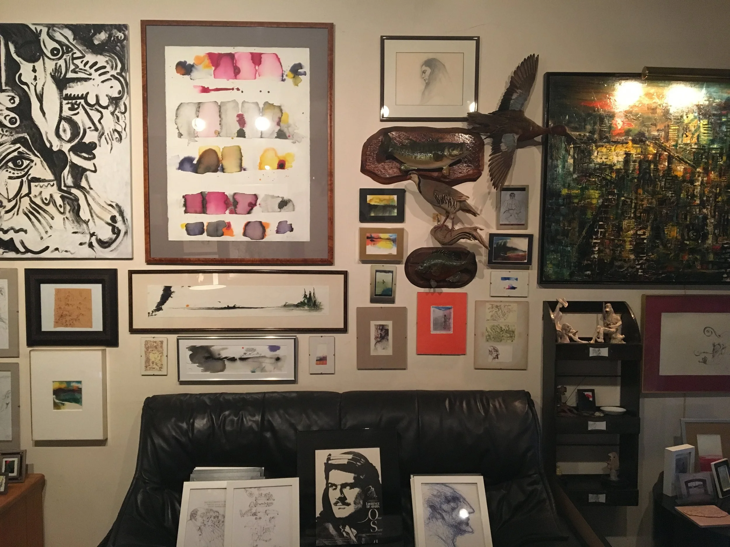 One wall of Sandy's living room, covered with his own work.