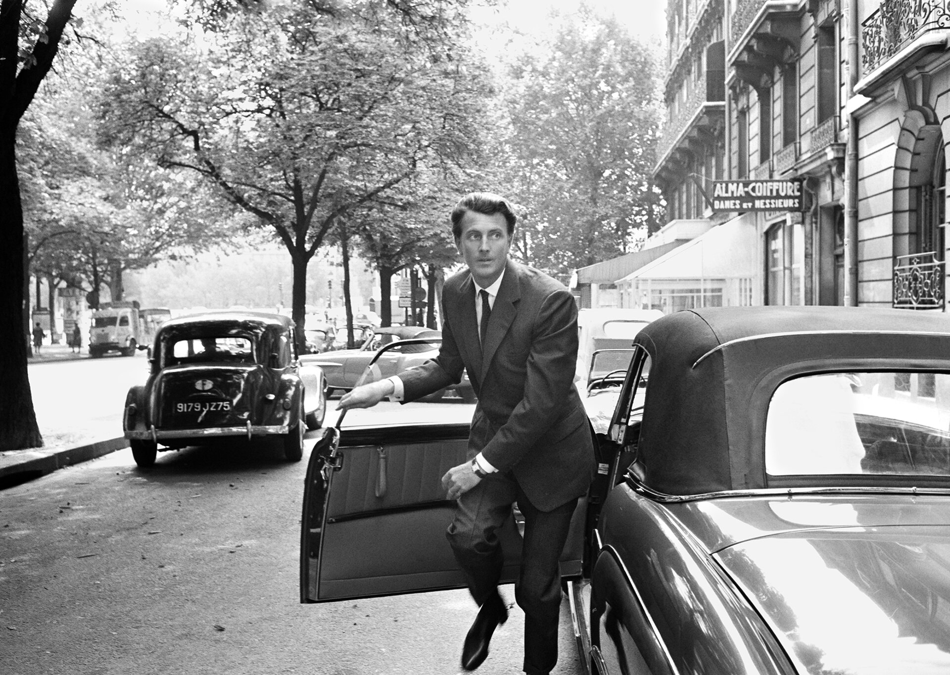 Hubert de Givenchy exits his car in Paris, 1960