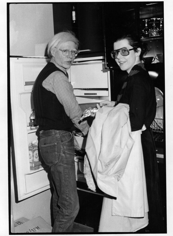 Andy Warhol giving Tere leftovers on Christmas 1976 , giving her leftovers, 1976. Photo by Pat Hackett.