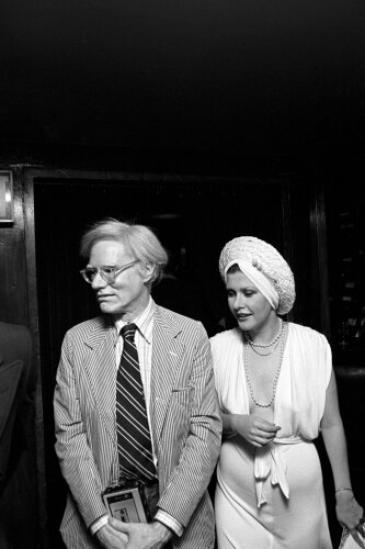 American artist Andy Warhol and American fashion designer and actress Tere Tereba at a Genevieve Waite debut party in New York City, 1974. Photo by Waring Abbott,