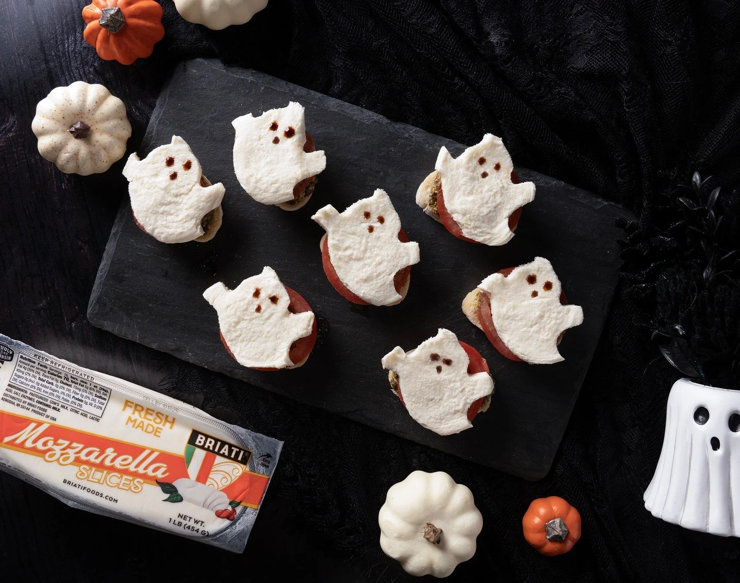 Boo-tiful bites for Halloween! 👻 Pesto, tomato, mozzarella ghosts, and a touch of balsamic glaze make the Italian way to snack spooky.