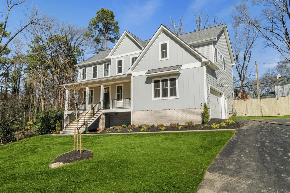 Gray Havelock with a full front porch and gable roof.