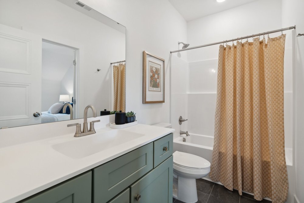 Secondary Bathroom in the Bonaire with a Fun, Green Vanity and Nickel Hardware
