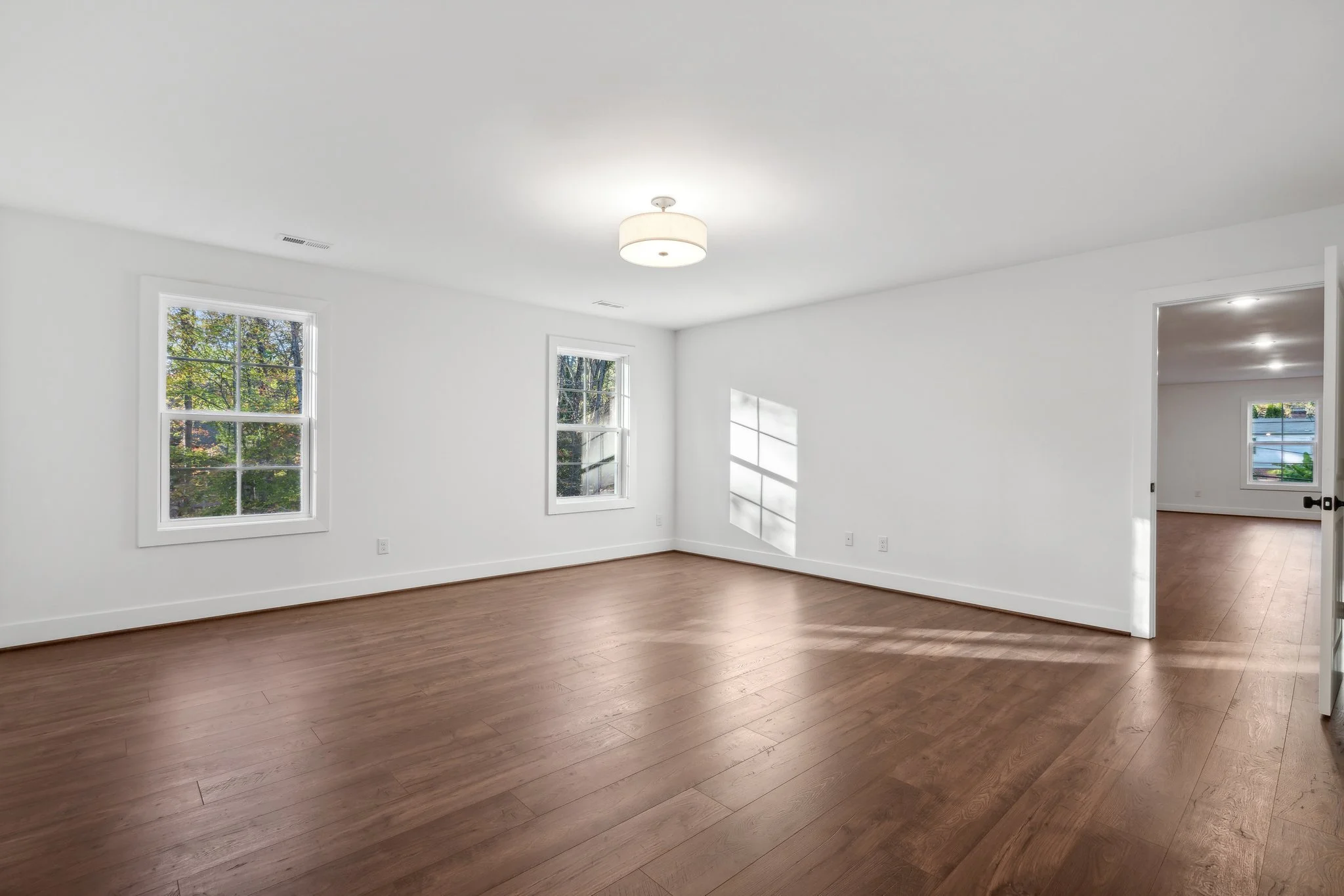 Bright and spacious bedroom with large windows.