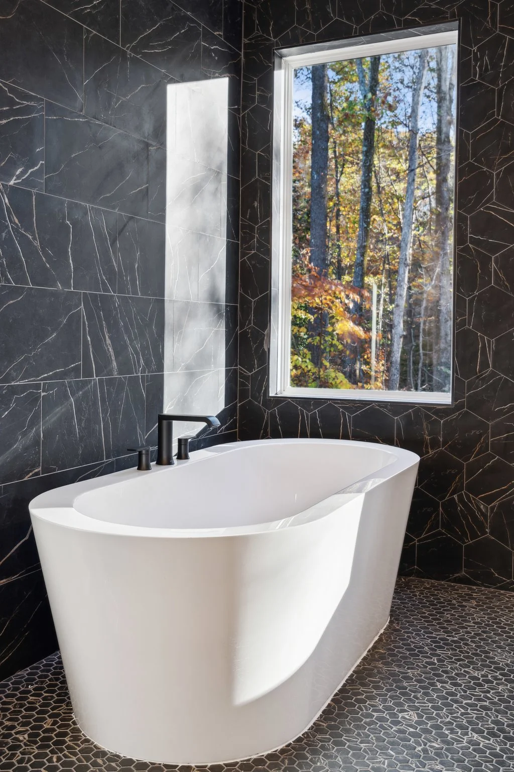 Close-up of freestanding bathtub with a scenic view