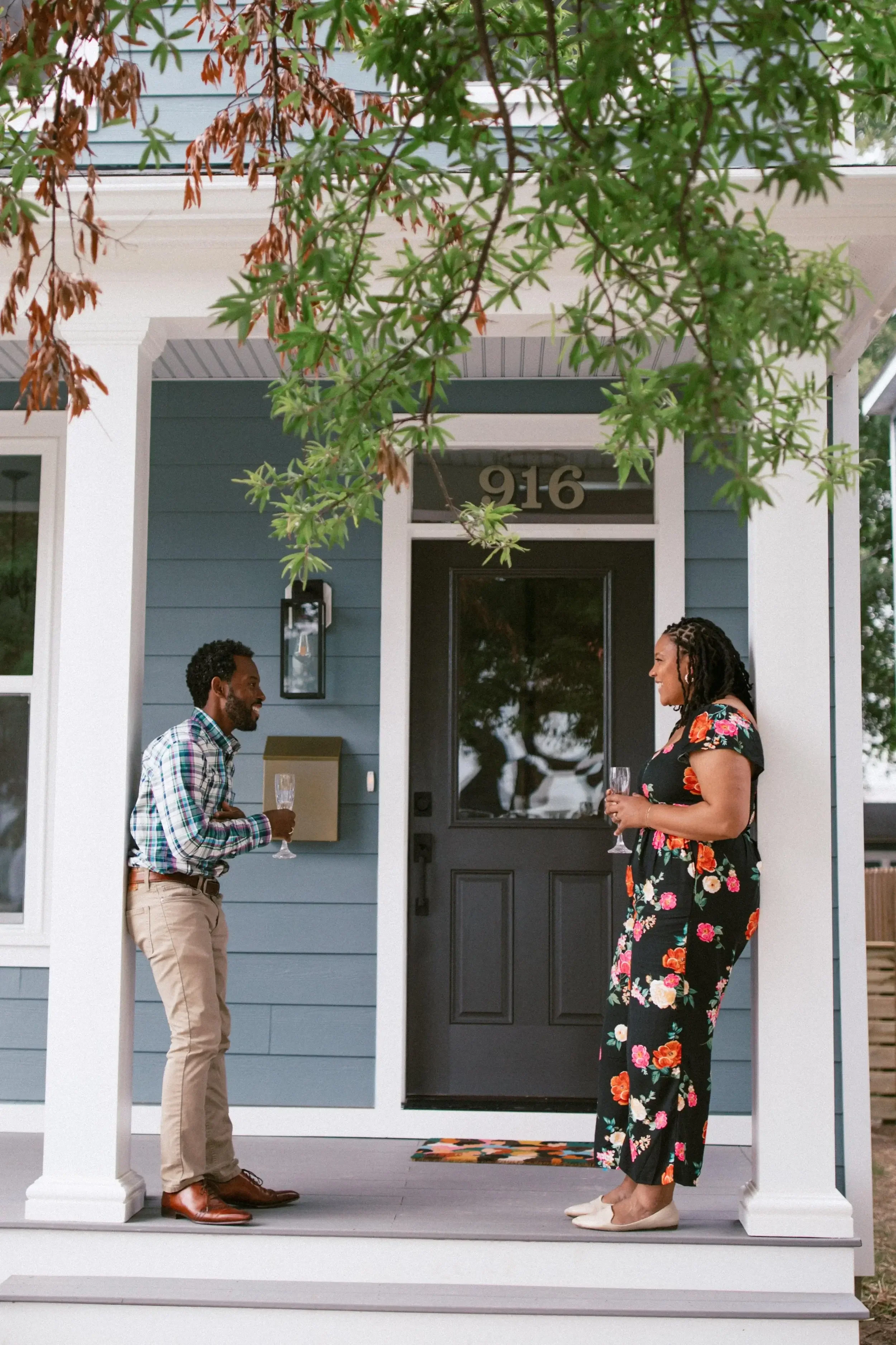 Homeowners enjoying the front porch of their new Keel custom home