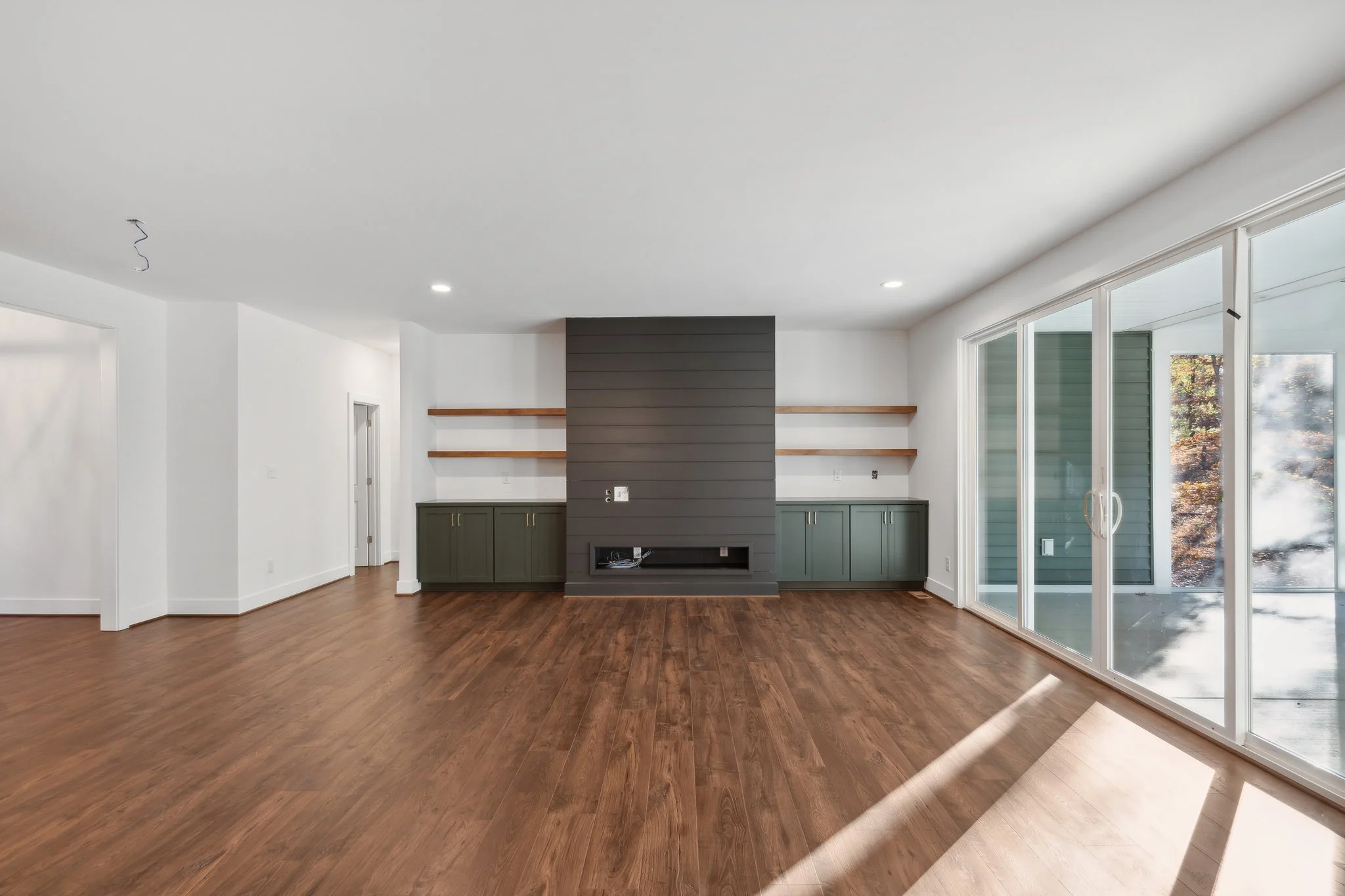 Living room with large windows and a sleek built-in fireplace