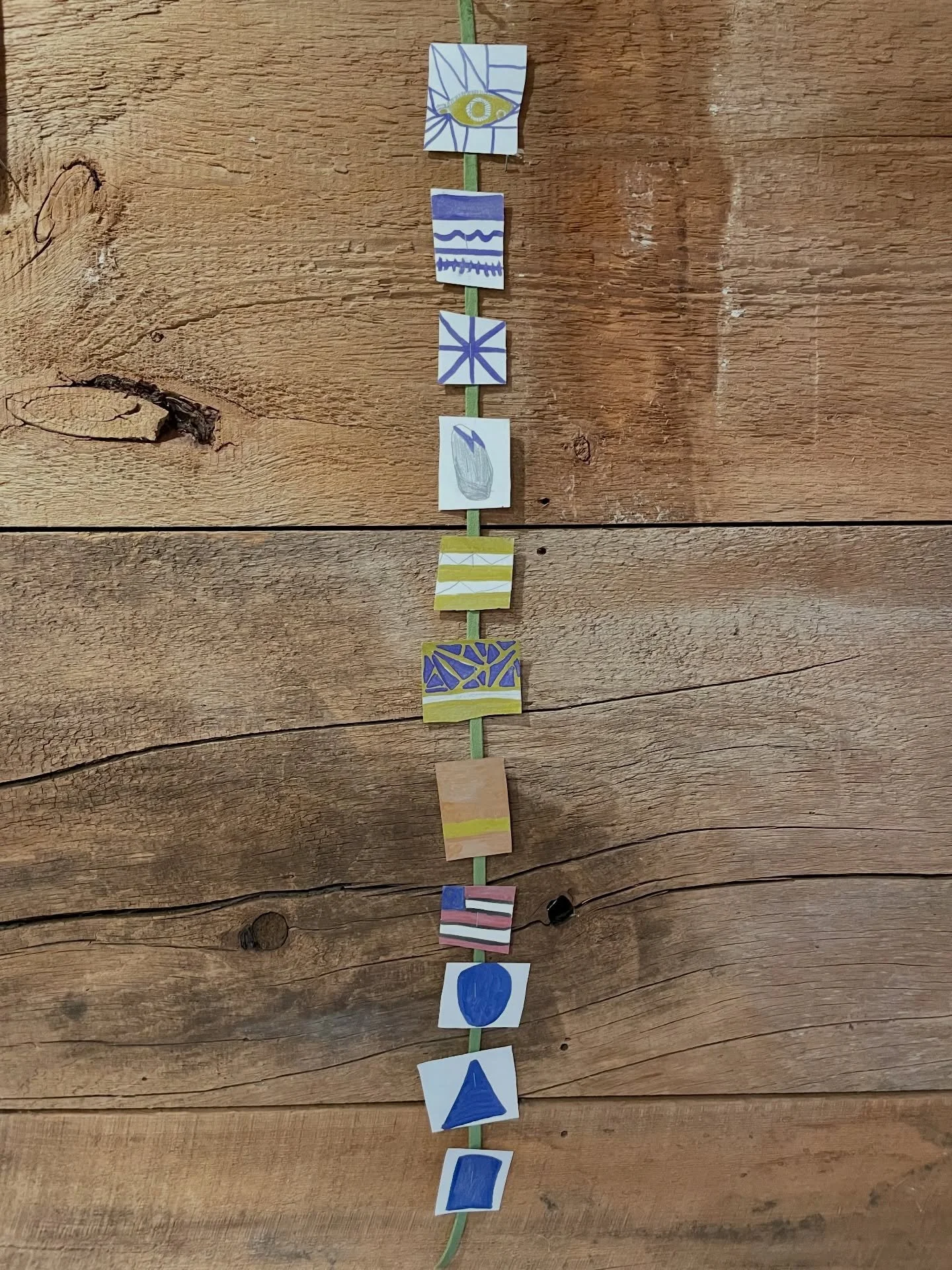 The children have been really interested in working in small format, so today we continued with a new idea. I invited them to create a hanging mini art show using markers and one simple direction: teach me something about art.

Each child chose a dif