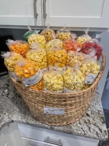 Basket of assorted flavored popcorn bags on a kitchen counter