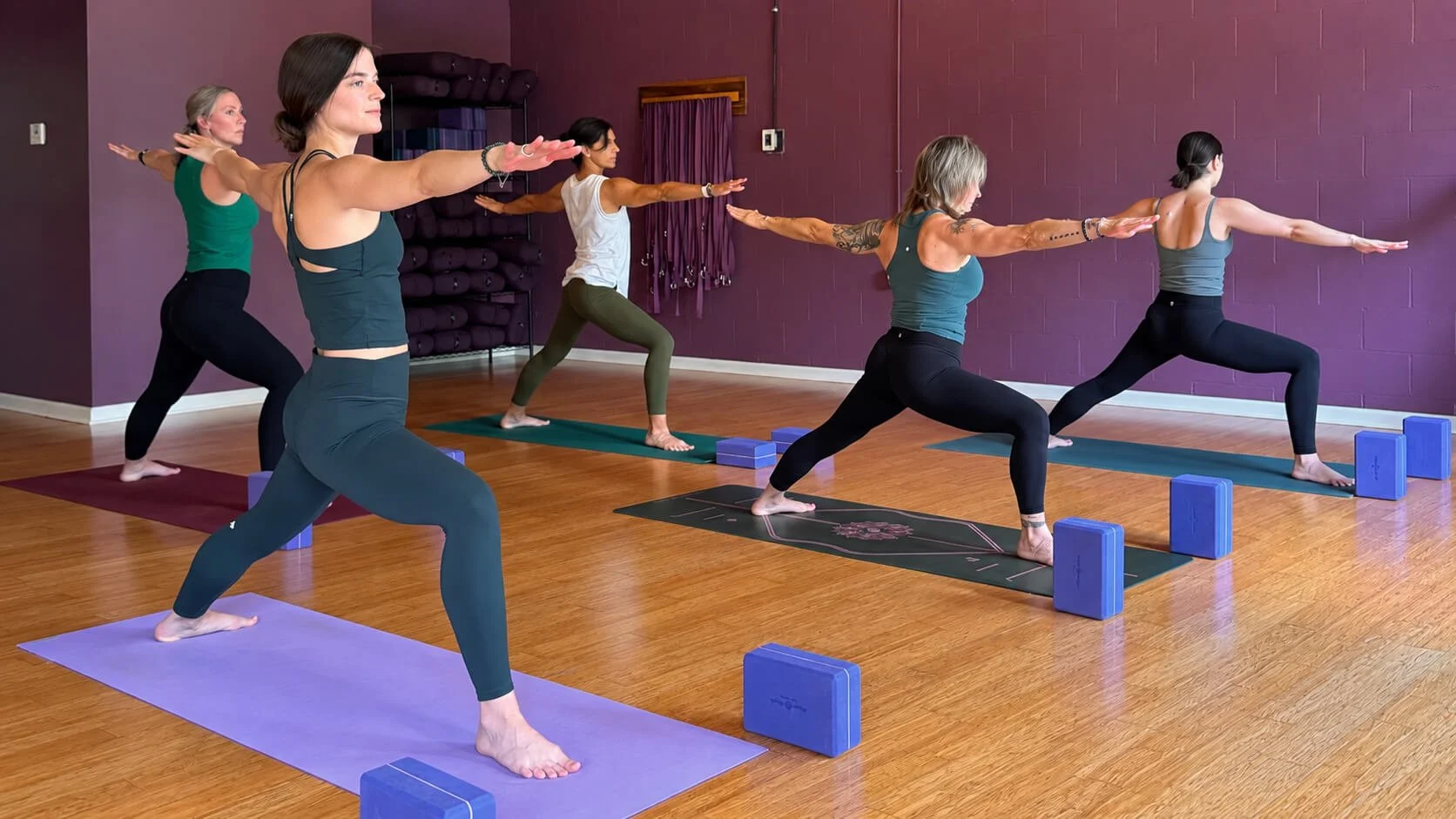Jessica Taddeo practicing yoga with students at Prana Yoga Center in Geneva, Illinois