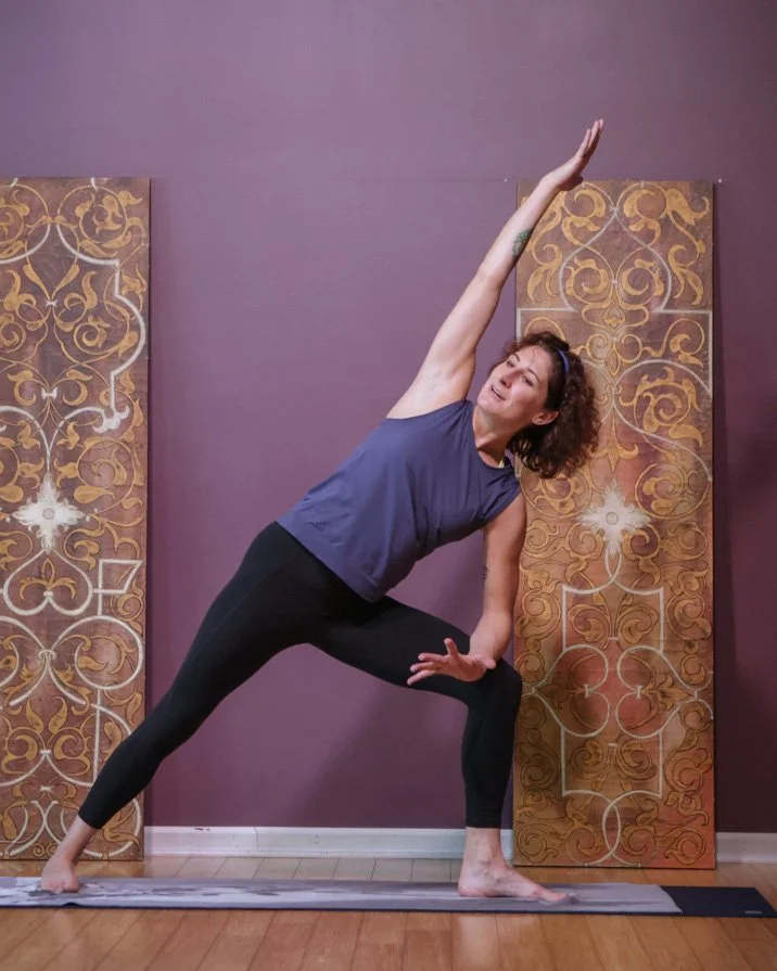 Kristen Kauke teaching an extended side angle yoga pose at Prana Yoga Center in Geneva, Illinois.”