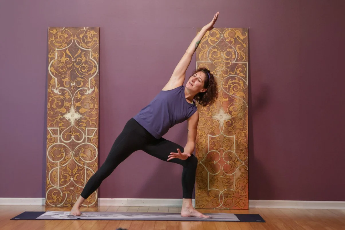 Woman practicing side angle pose during Yoga Fundamentals class at Prana Yogta e