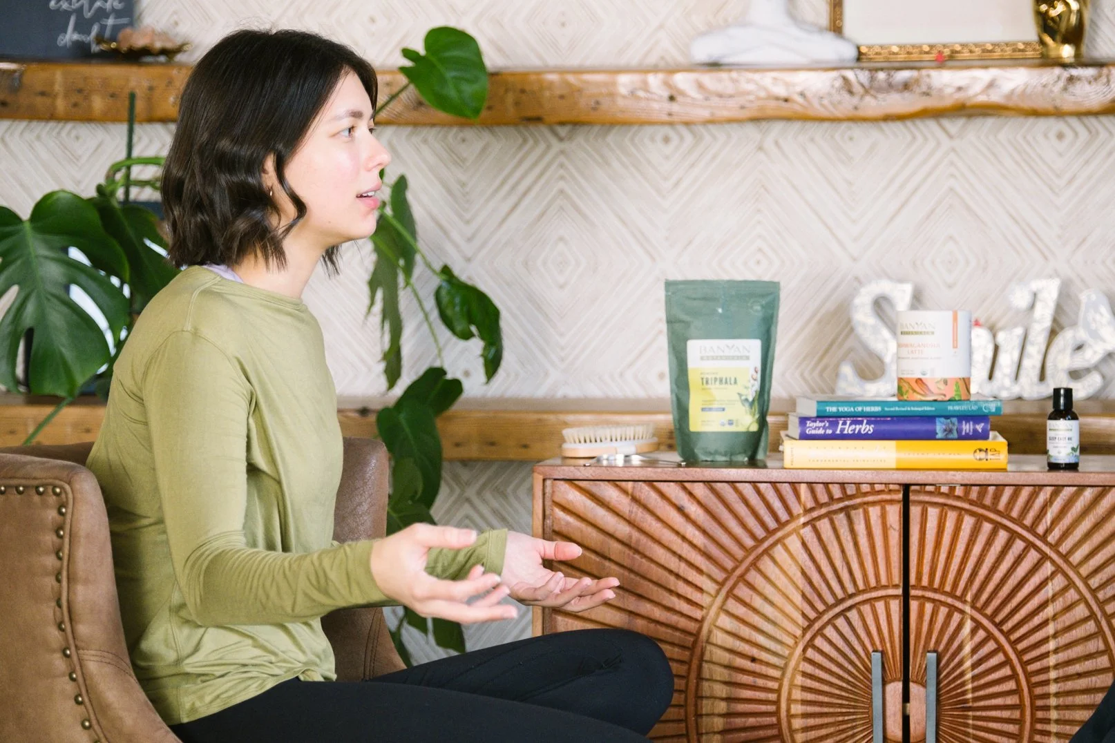 Ayurveda practitioner explaining wellness concepts during educational session at Prana Yoga Center