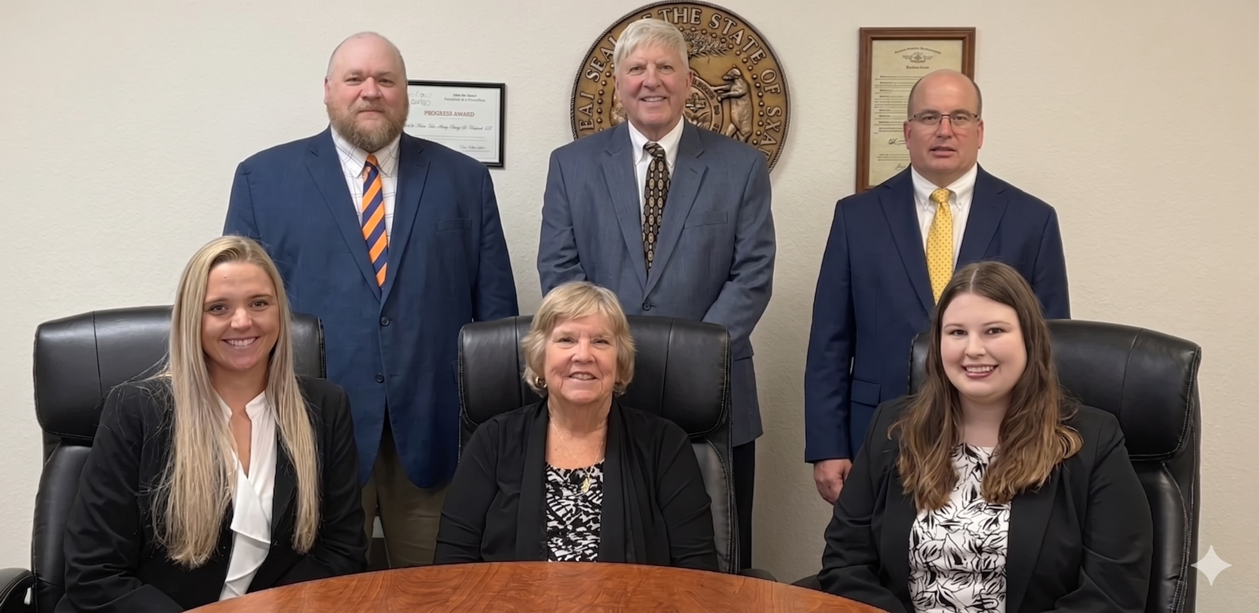 attorney team gathered around a conference table