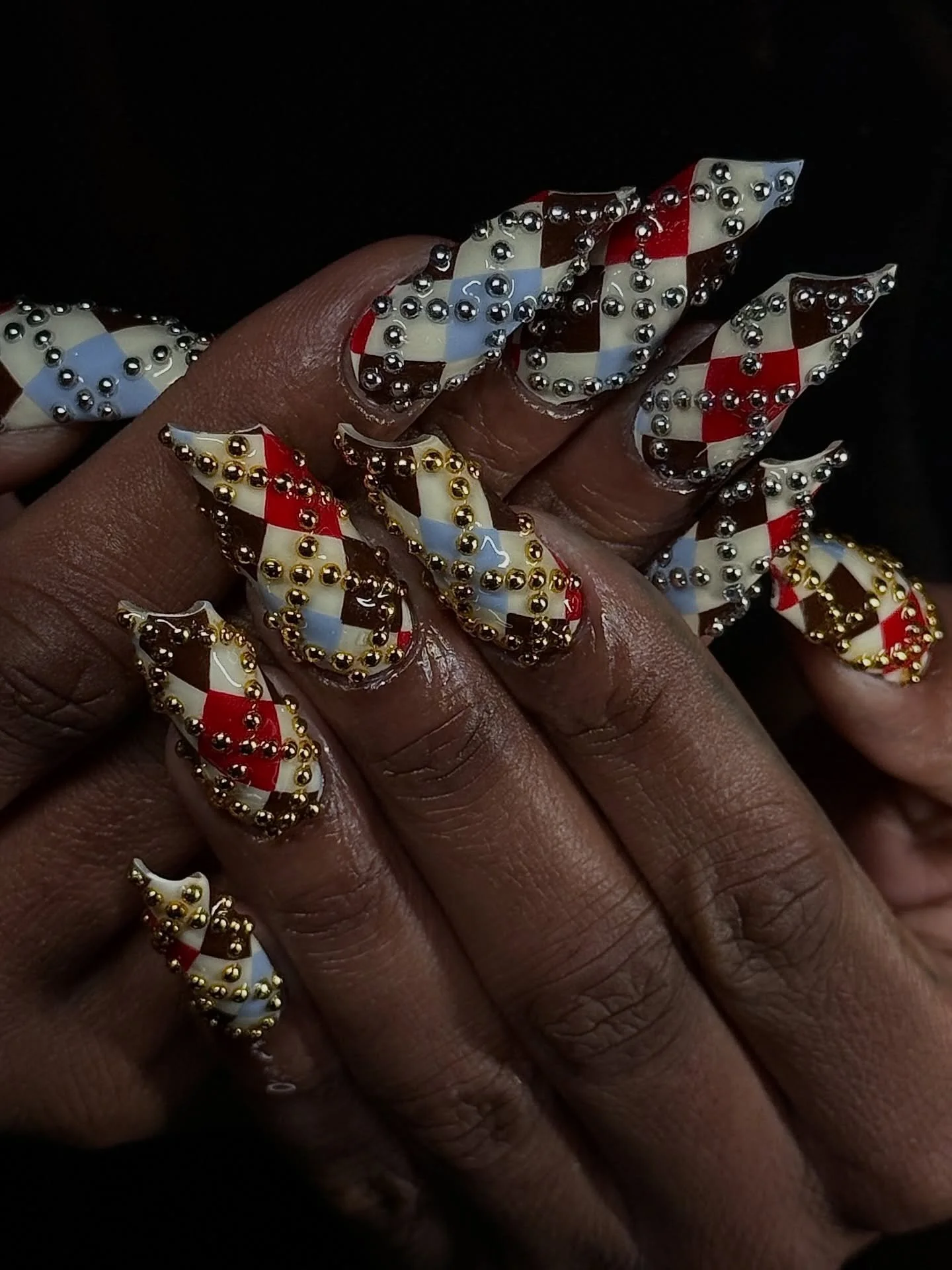 This studded argyle is everything! Lipstick extensions by Serena @serenadidem! ⁠
.⁠
Gel-X &bull; Level 4 
📍179 Orchard Street, NYC ⁠
⁠
ID: Red, blue, and brown plaid nail design with studded gems by NYC-based nail tech in Lower East Side Manhattan