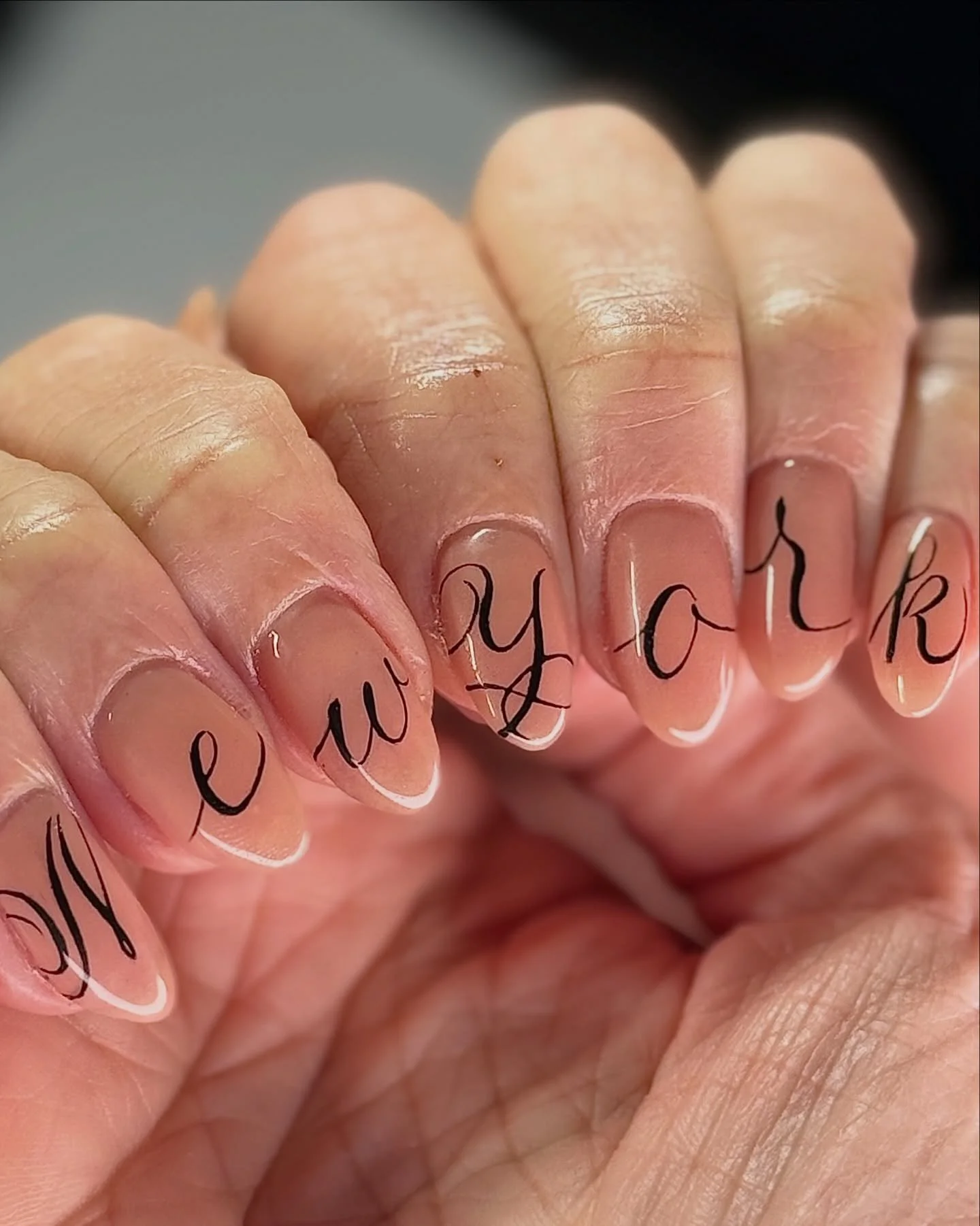 The best city in the worlddd 🗽 This hand-painted cursive is absolutely insane, by Ruby @nailzonmarz⁠
.⁠
Structured Manicure &bull; Level 2⁠
📍Lower East Side NYC ⁠
⁠
#nycnailtech #biab #structuredgel #nailart