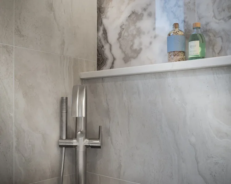 Custom shower niche with built-in ledge and handheld showerhead