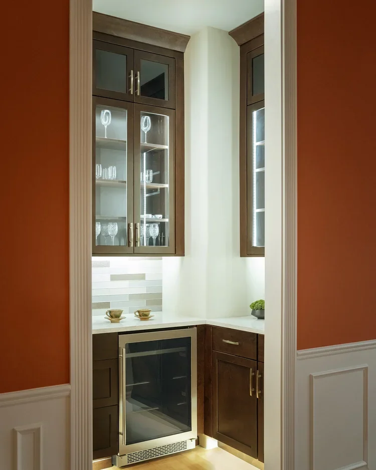 Built-in bar with glass-front cabinets and wine fridge