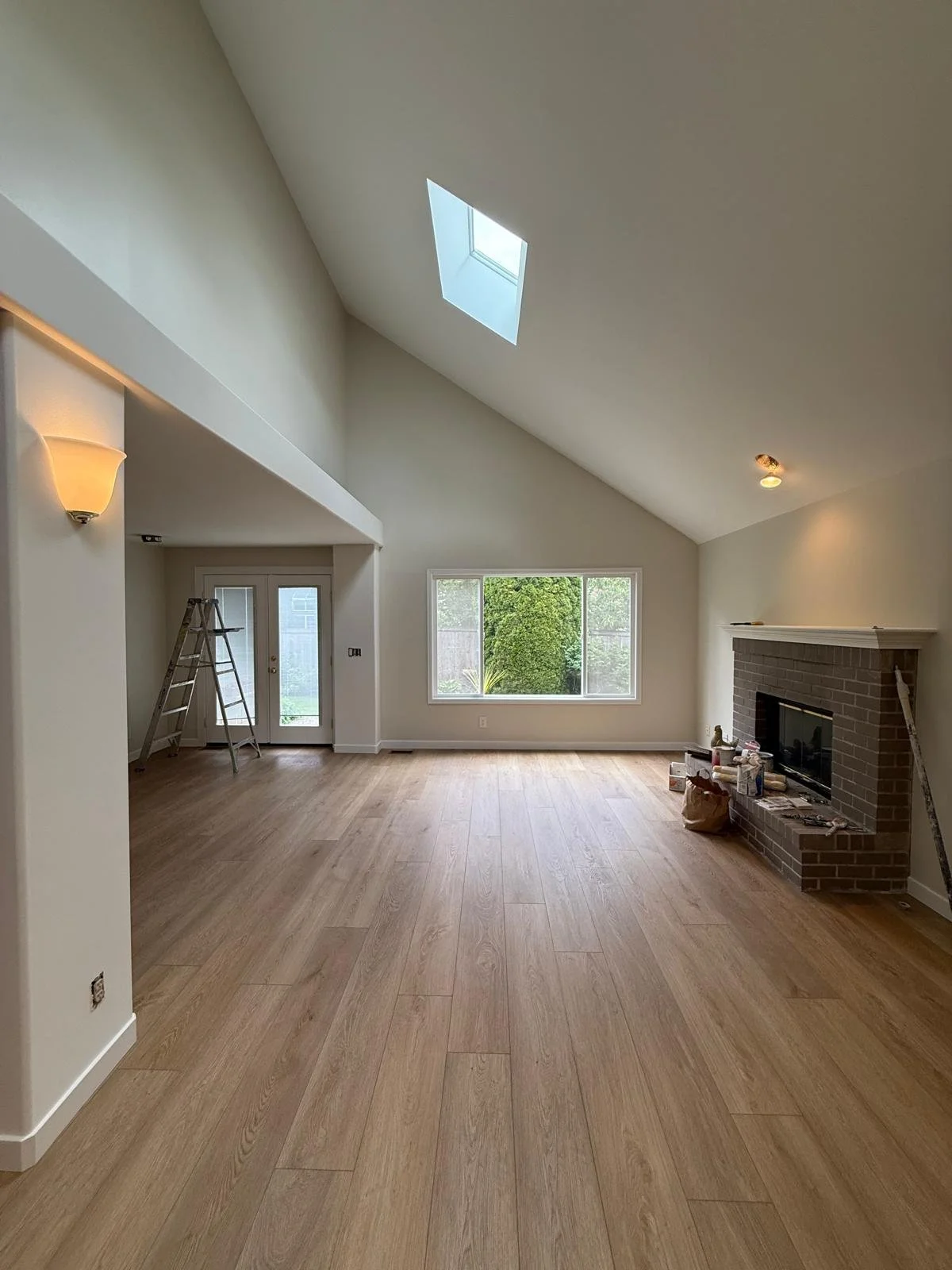 Vaulted great room with skylight and new hardwood floors