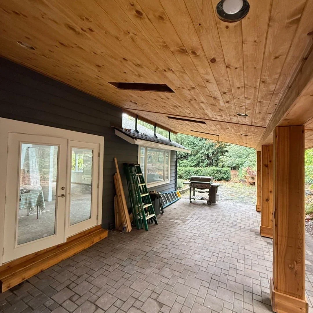Covered patio with wood plank ceiling, cedar posts and stamped concrete