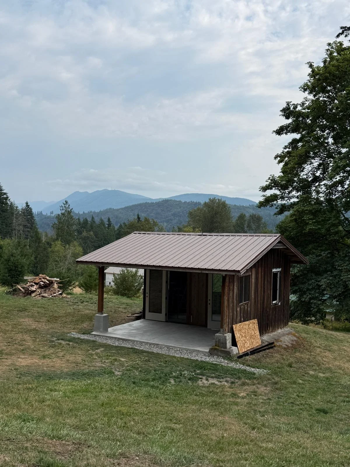 Detached outbuilding with covered porch and mountain view