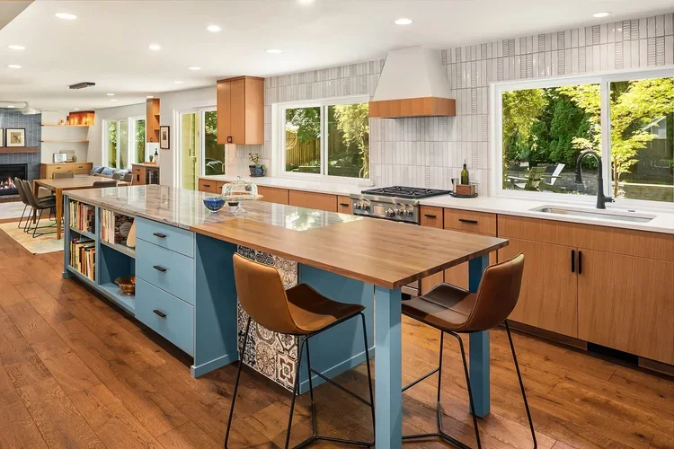 Wood kitchen cabinets with blue island and seating