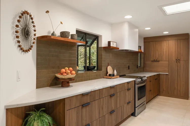 Wood kitchen cabinets with open shelving, tile backsplash and quartz counters