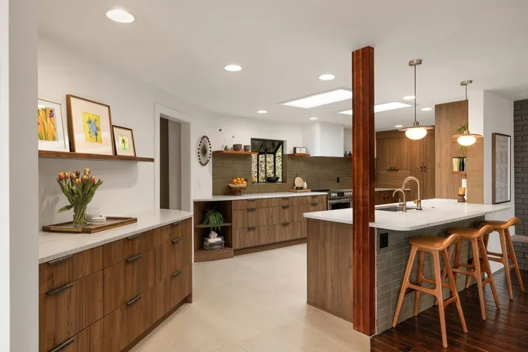 Open kitchen with exposed wood post, island seating and pendant lights