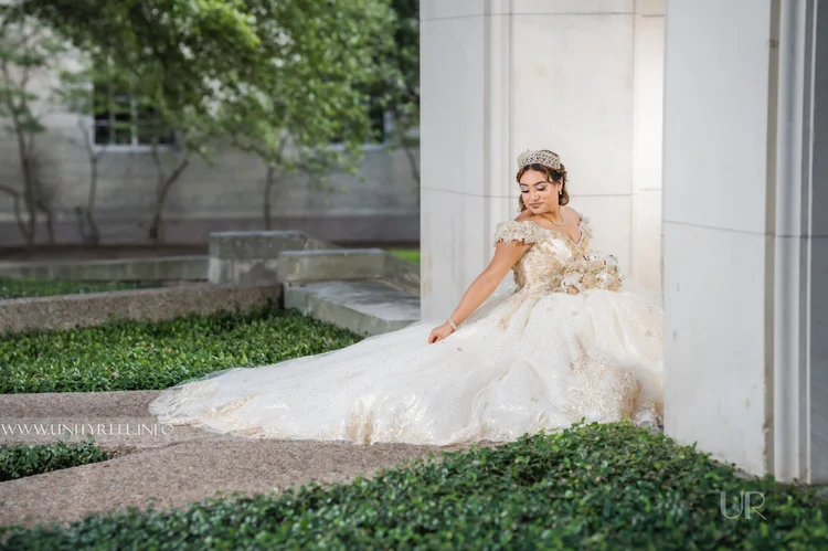 Portrait of a woman in an embellished white gown and tiara.