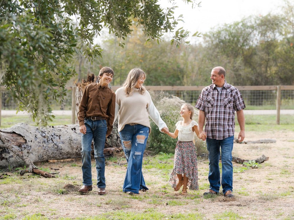 Family sharing a relaxed walk together during their portrait session