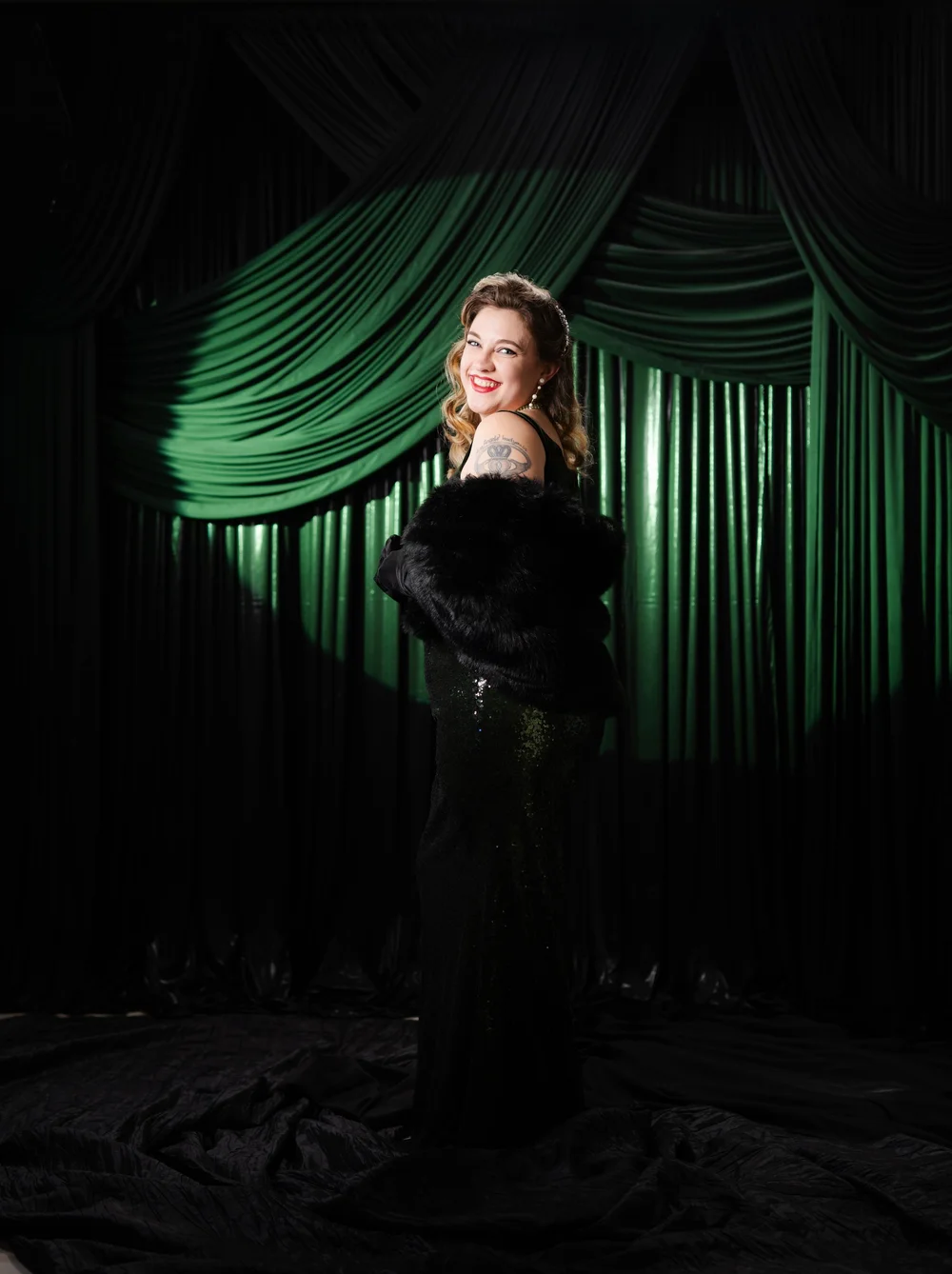 Guest in an evening gown, photographed in The Spotlight's dramatic studio lighting