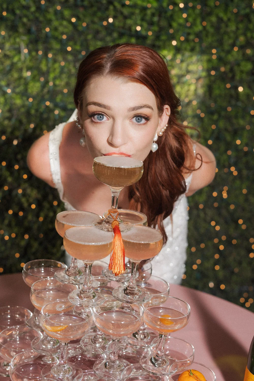 Bride celebrating with a champagne tower at her wedding reception