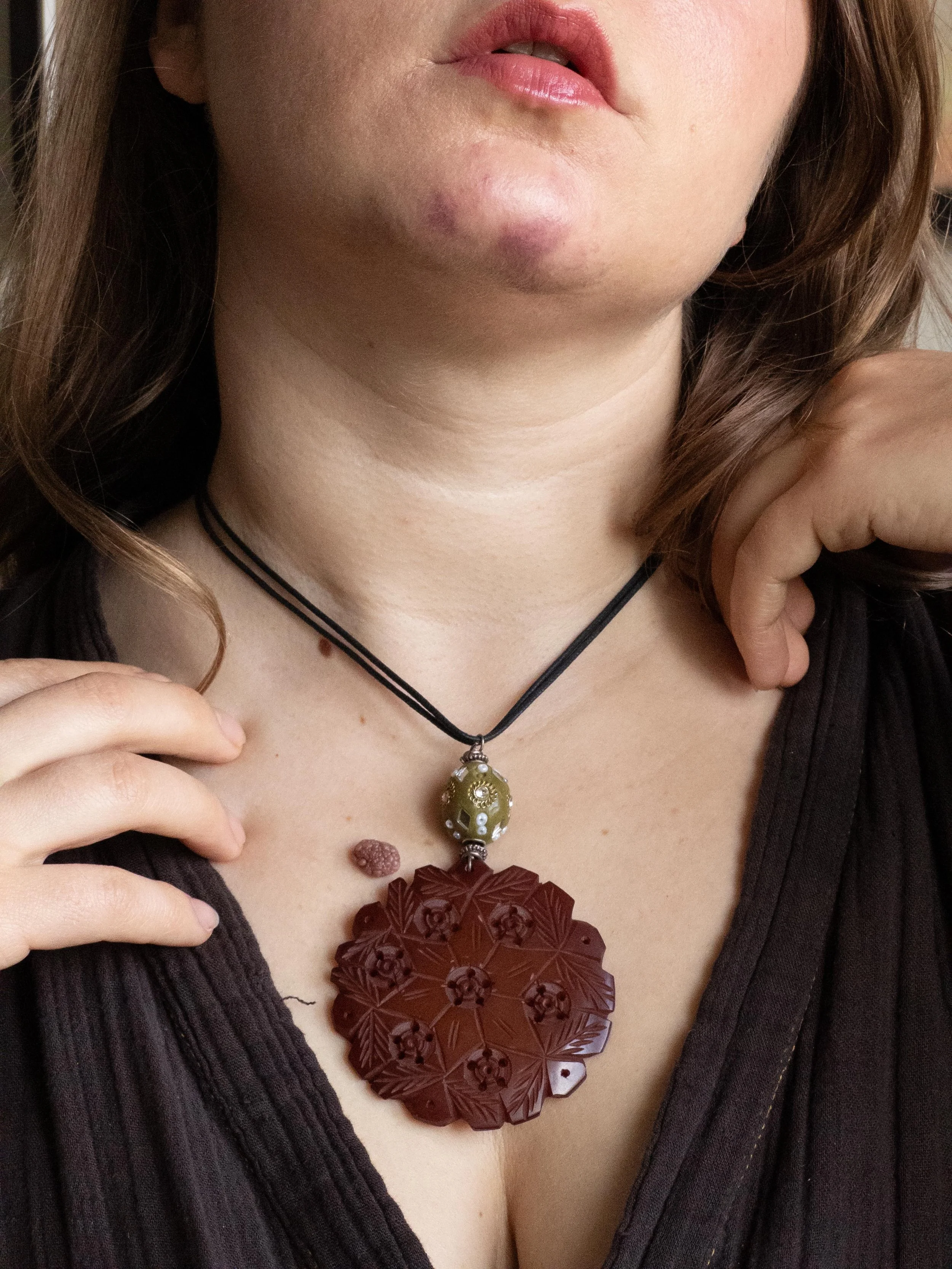 Vintage Leather Cord Necklace with Carved Floral Pendant and Green Glass Bead