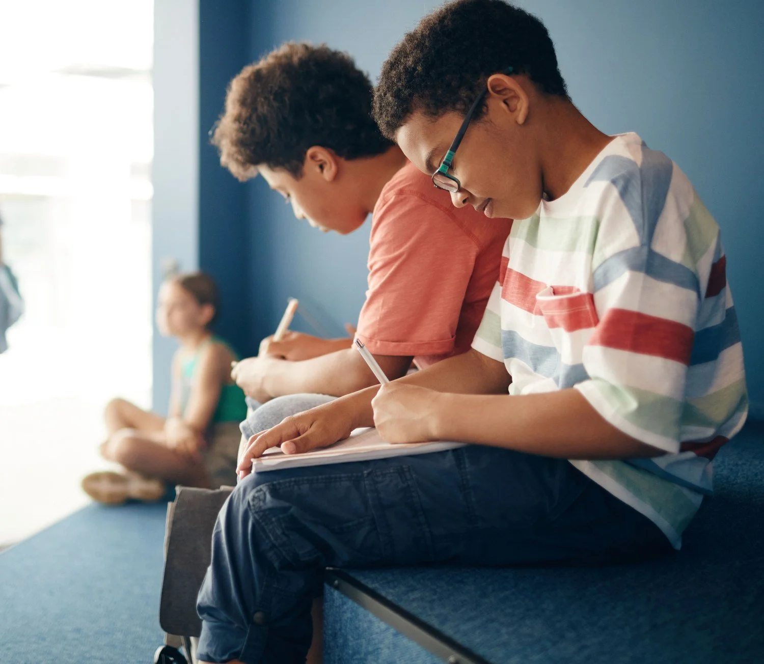 Student writing in a notebook