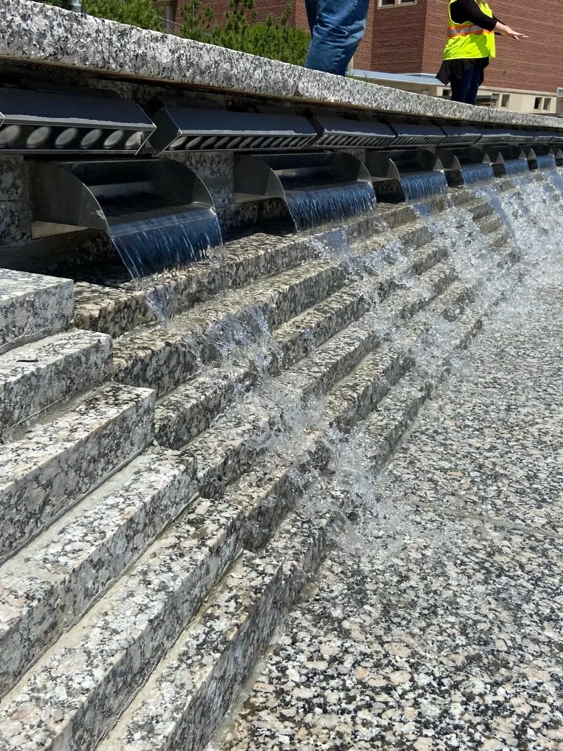 water cascading over granite layers in fountain.