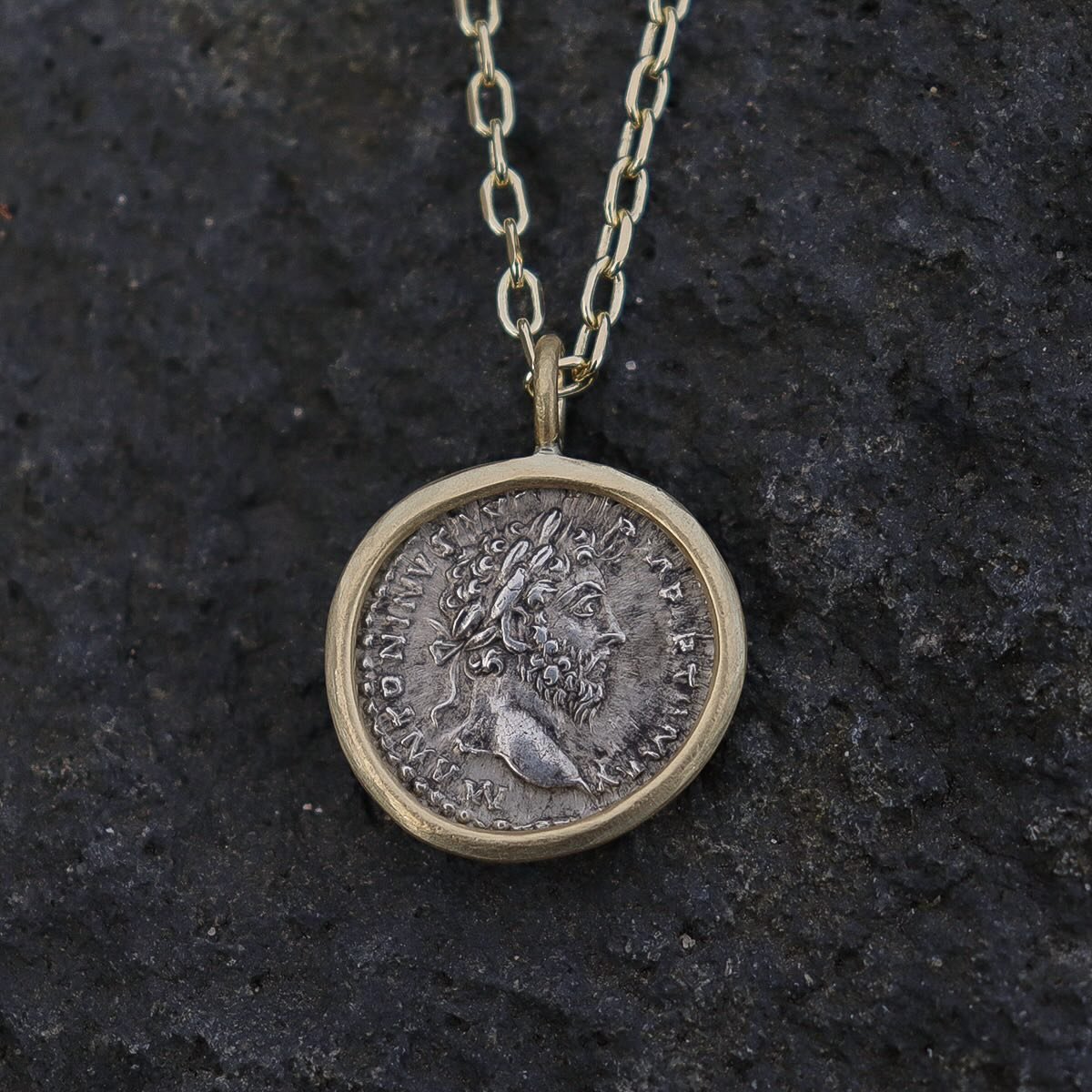 Setting the Roman emperor and philosopher, Marcus Aurelius in 18ct gold. It was a tricky wee project as the edges of the silver coin were quite uneven. It is 1850 years old after all.
A buttery, textured gold setting and a heavyweight 18ct gold chain