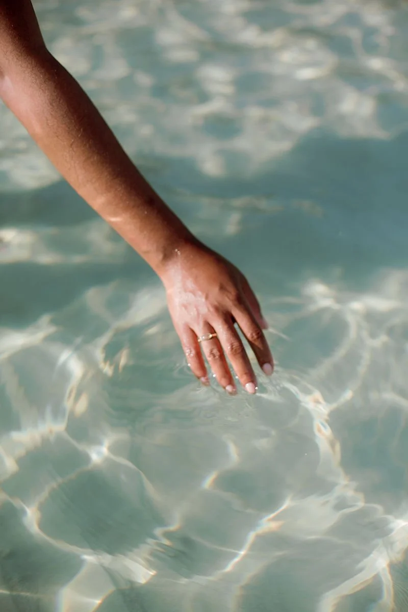Hand gliding through calm water