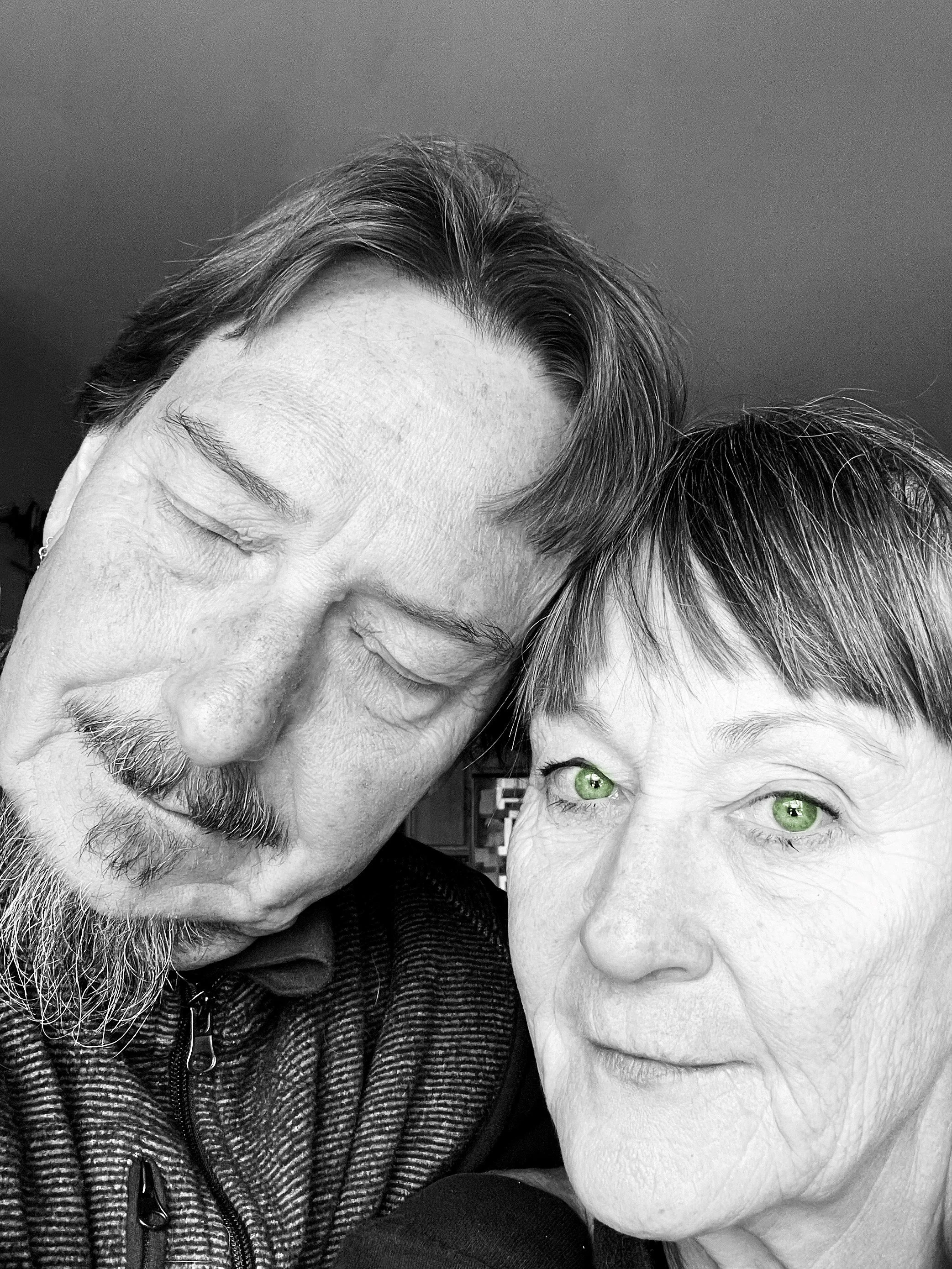 Photo of Briggs Geister and Kevin Leis aka Rose and the Thorn heads together with button to listen to their music