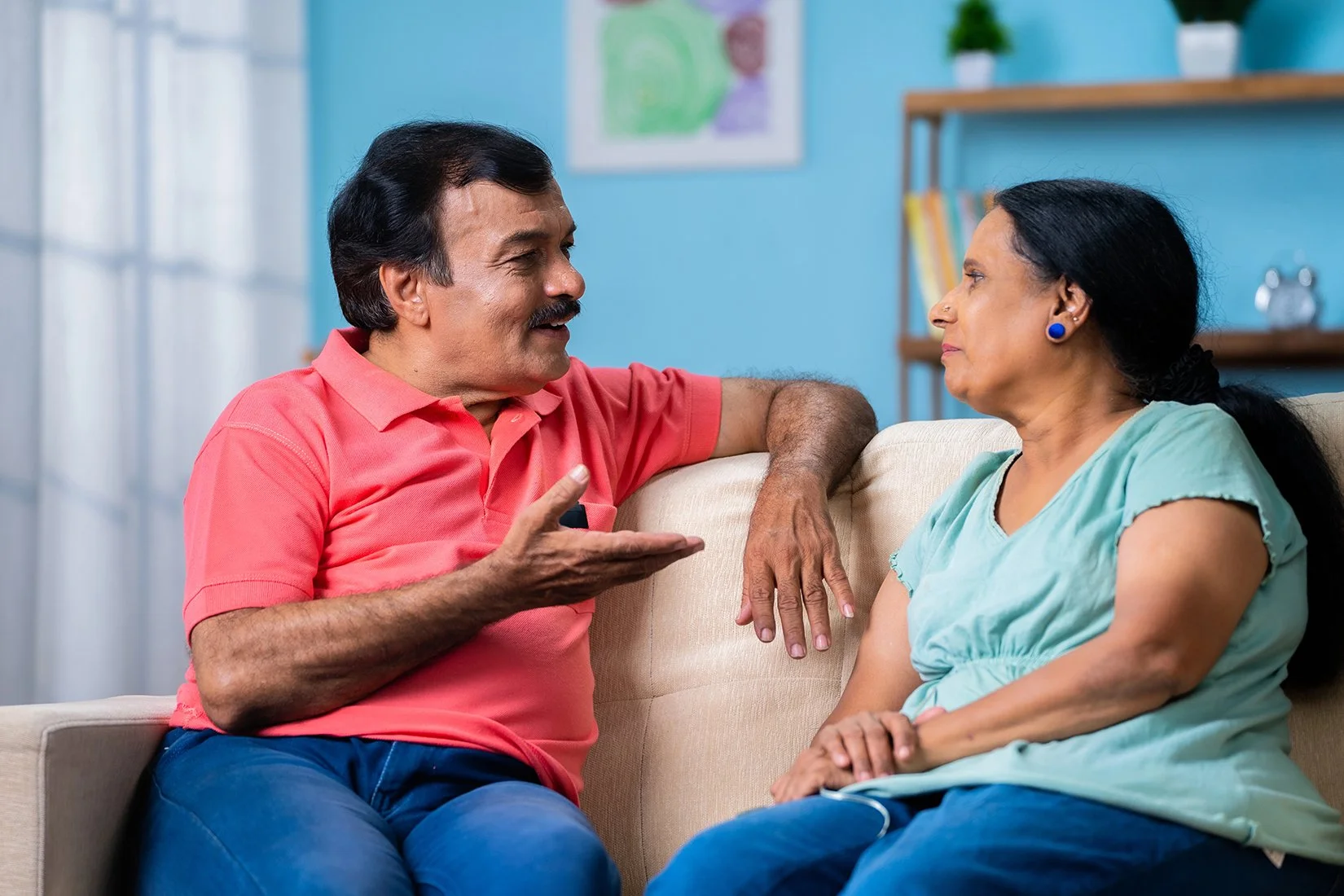 A middle aged Indian couple practicing active listening and emotional validation to improve communication in their relationship.