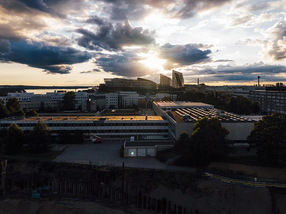 Valokuva Tampereen yliopistosta. Aurinko laskee Tampereella